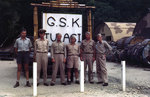 Several US Navy officers posed by a facility sign on Tulagi, Solomon Islands, circa 1945