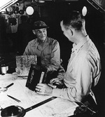 Vice Admiral Mitscher and Commodore Burke aboard carrier Randolph off Okinawa, Japan, 1945, photo 1 of 2