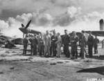 Claire Chennault with Chinese officers at an airfield, Kunming, Yunnan Province, China, 1942-1943; note P-40 fighters