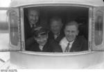 German pilot Christiansen, American pilot Schildhauer, and others at an open window of a Do X flying boat before making a trans-Atlantic flight from Europe to North America, Nov 1930