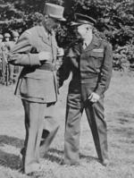 General Charles de Gaulle talking with General Dwight Eisenhower during an inspection of US troops at Eisenhower