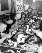 Admiral William Halsey having Thanksgiving dinner with the crew of battleship USS New Jersey, his flagship, 30 Nov 1944