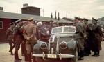 Heinrich Himmler in passenger seat of a sedan in the ghetto of Litzmannstadt/Lodz, Poland, Jun 1941; the white-haired civilian next to the vehicle was Chaim Rumkowski, chairman of the Jewish Council