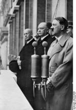 Hitler speaking to 15,000 rail workers from balcony of Reich Chancellery, 4 Feb 1937; Government Secretary Hans-Heinrich Lammers and Minister of Transport Julius Heinrich Dorpmüller next to Hitler