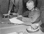 Wilhelm Keitel signing surrender documents at the Soviet headquarters near Berlin, Germany, 8 May 1945