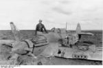 Hans-Joachim Marseille with a British Hurricane fighter that he had shot down, Libya, Mar 1942, photo 1 of 3