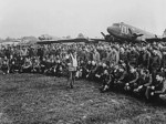 US Army Brigadier General Anthony C. McAuliffe speaking to his glider pilots, England, United Kingdom, 18 Sep 1944; note C-47 Skytrain and CG-4A glider aircraft in background