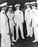 Admiral Mitscher and Commodore Burke aboard USS Franklin D. Roosevelt, 7 May 1946; other officers were Captain Thomas Regan, Vice Admiral Bernhard Bieri, and Lieutenant Commander Remington