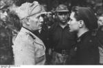Benito Mussolini speaking with a Black Shirt soldier, Italy, 1944