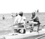 Benito Mussolini rowing a boat with lifeguard Pasquale Corazza and his son Romano Mussolini, Riccione, Italy, 1932