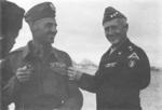 Polish General Wladyslaw Anders and American Lieutenant General George Patton exchanging award insignias, Europe, mid-1944