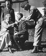 Franklin Roosevelt awarding Brigadier General William Wilbur the Medal of Honor, Casablanca, French Morocco, 22 Jan 1943; note George Marshall in background and George Patton assisting. Photo 1 of 2.