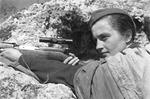 Lyudmila Pavlichenko posing with her SVT-40 sniper rifle for a publicity photo shoot, 1942