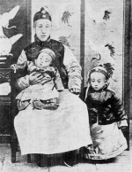 Prince Chun (seated), Xuantong Emperor (standing), and Prince Pujie (in lap), Beijing, China, 23 Feb 1909