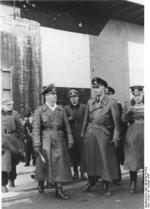 Field Marshal Erwin Rommel and Vice Admiral Friedrich Oskar Ruge touring a submarine pen on the Atlantic coast, France, 12 Feb 1944