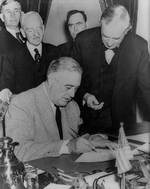 Franklin Roosevelt signing the Declaration of War against Germany, 11 Dec 1941; Senator Tom Connally at right marked the exact time of declaration. Photo 1 of 2.
