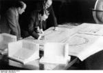 Albert Speer, Adolf Hitler, and architect Ruff reviewing the plans for the Nazi Party rallying ground to be built at Nürnberg, Germany, circa 1934-1935