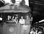 Harry Truman with his wife Bess and daughter Margaret waving from the train during the 1948 Presidential campaign, somewhere in the United States, 2 Oct 1948