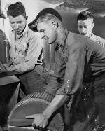Sailors handling gun powder aboard USS Alabama, off Japan, 1945