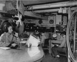 Lieutenant Charlie Wadsworth, Ray Elliott, Howard Arb, and Jack Whirson in the combat information center aboard USS Anzio while the ship was off Okinawa, Japan, 21 Apr 1945