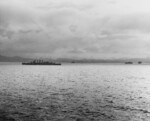 HMAS Canberra and three Allied transports off Tulagi island (closer in background) and Florida island (further in background) during landing operations, 7-8 Aug 1942