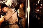 Commander David White (at periscope) and Lieutenant Commander David McClintock (center) in the conning tower of USS Cero during a simulated torpedo attack, Groton, Connecticut, United States, Aug 1943