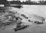 Dead Japanese soldiers and wrecked Daihatsu-class landing craft on Buna beach, New Guinea, 1943