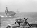 HMS Indomitable and HMS Eagle sailing behind HMS Victorious, 3-10 Aug 1942; note Hurricane and Albacore aircraft on Victorious