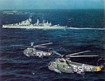 Two SH-3A Sea King helicopters flying past HNLMS De Zeven Provinciën and USS Essex in the Mediterranean Sea, 1967