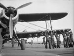 Sailors pushing an armed Albacore aircraft of No. 820 Squadron FAA into position aboard HMS Formidable, off North Africa, Nov 1942