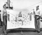 US Navy sailors Roscoe Wells and Bernard Manning holding USS Gar