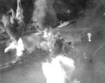 Bombs and torpedos from US Third Fleet carrier aircraft exploding around battleship Haruna, Japan, 28 Jul 1945