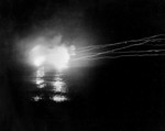 USS Helena performing night time bombardment of Japanese positions in the Munda-Vila area, New Georgia, Solomon Islands, 13 May 1943; photo taken from USS Honolulu