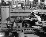 Indianapolis at Mare Island Navy Yard, California, view of her well deck area from port side, with light cruiser Raleigh in background, 19 Apr 1942; note SOC Seagull aircraft onboard