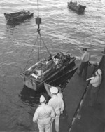 Wounded personnel being loaded from USS Intrepid into waiting LCVP landing craft, probably at Ulithi, Caroline Islands, 1944, photo 2 of 2