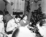 Actor Mickey Rooney eating in the USS Intrepid crews mess during a Christmas visit in California, United States, Dec 1943