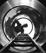 An American sailor looking down the hatch of submarine USS Marlin at New London, Connecticut, United States, Aug 1943