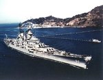 Battleship New Jersey entering into a Japanese port during her second Korean War tour, circa Apr-May 1953; note harbor defense nets