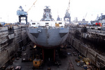 Stern view of battleship New Jersey in drydock while undergoing refitting for reactivation, Naval Shipyard, Long Beach, California, United States, 5 Feb 1982