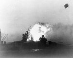 USS New Mexico hit by a special attack aircraft at dusk off Okinawa, Japan, 12 May 1945; photo taken from cruiser USS Wichita