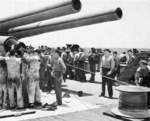 Cleaning the gun barrels aboard USS North Carolina, Jul 1945