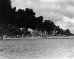 Phoenix steaming past burning wrecks of battleships West Virginia and Arizona, Pearl Harbor, US Territory of Hawaii, 7 Dec 1941
