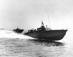 PT-105 and two other torpedo boats of US Navy Motor Torpedo Boat Squadron Five running at high speed during exercises off the US east coast, 12 Jul 1942