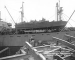 PT-109 stowed on board the Liberty Ship Joseph Stanton for transportation to the Pacific Ocean, Norfolk Navy Yard, Virginia, United States, 20 Aug 1942, photo 1 of 2