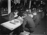 View of the mess hall aboard HMS Rodney during tea time, 1940