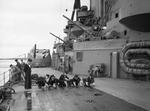 Sailors washing down the decks aboard HMS Rodney, 1940