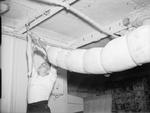 Sailor aboard HMS Rodney setting up his hammock, date unknown