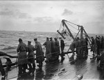 Crew of HMS Rodney lowering a paravane into the water, date unknown