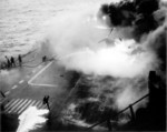 Following an attack from Japanese special attack aircraft, fires grew in the forward hangar deck of USS Saratoga off Iwo Jima, 21 Feb 1945. The fires increased greatly before they could be controlled. Photo 3 of 3