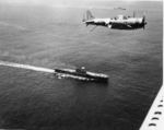SBD Dauntless aircraft flying over USS Enterprise (foreground) and USS Saratoga (background), off Guadalcanal, Solomon Islands, 19 Dec 1942